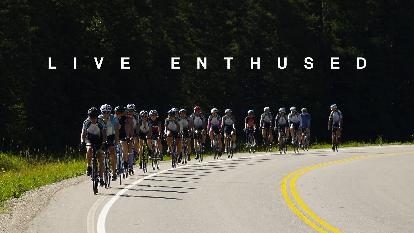 Group of cyclists on a road with 'Live Enthused' text above